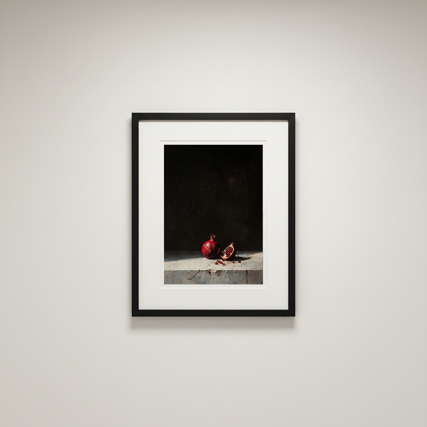 Framed artwork of pomegranates on a dark background in a minimalistic setting.