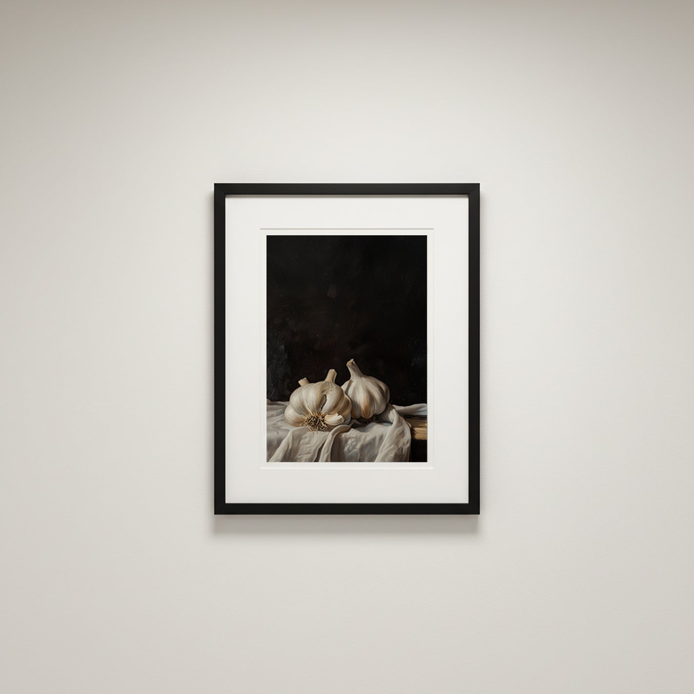 Framed artwork of garlic bulbs on a dark background, displayed on a light wall.