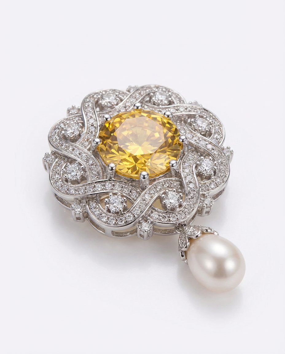 Elegant jewelry piece with yellow gemstone, pearl, and intricate silver design on a white background