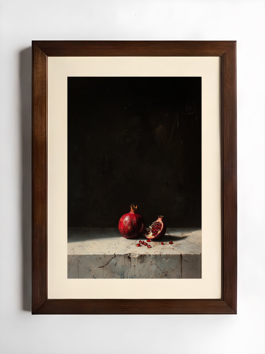 Framed still life photograph of pomegranates on a dark background
