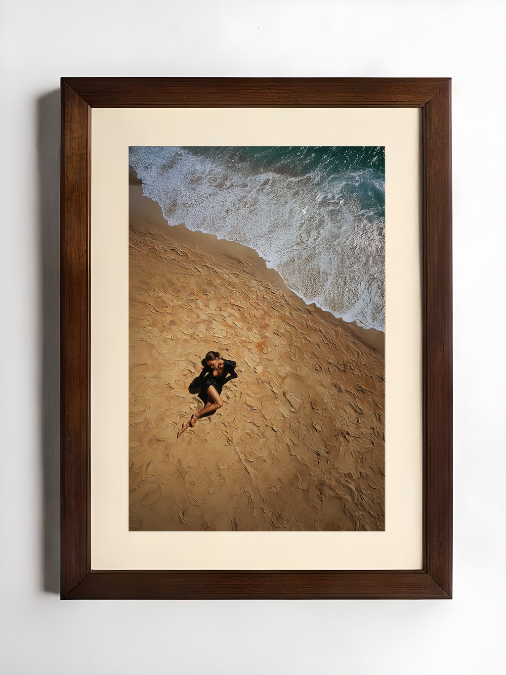 Framed artwork of a couple embracing on a beach with waves in the background