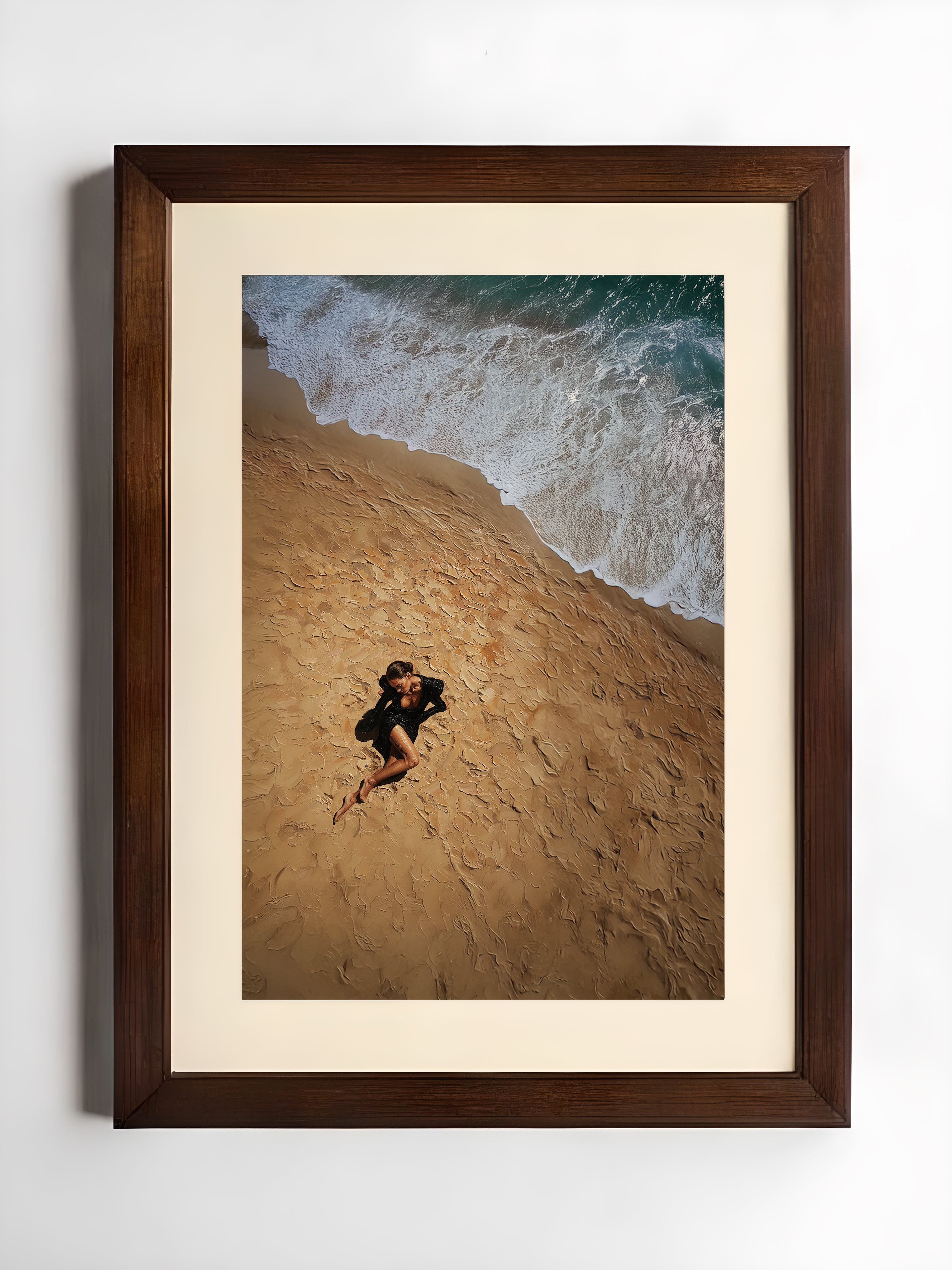 Framed artwork of a couple embracing on a beach with waves in the background