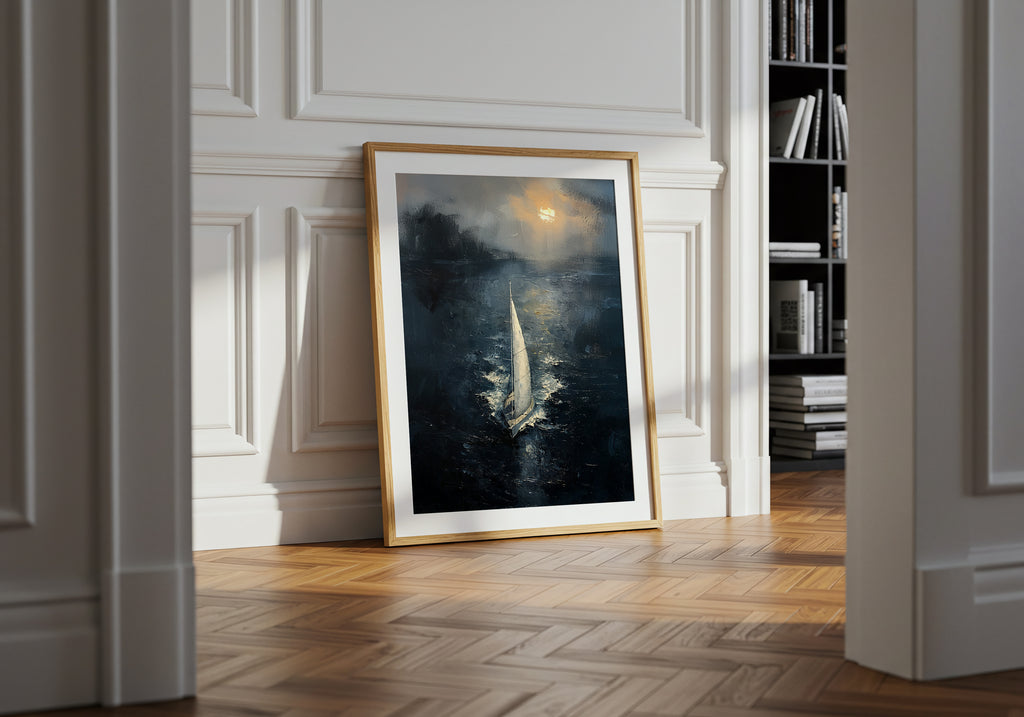 Fine art print of a solitary sailboat gliding across a dark, moody sea under a glowing horizon, framed in a black gallery frame with a white mat.