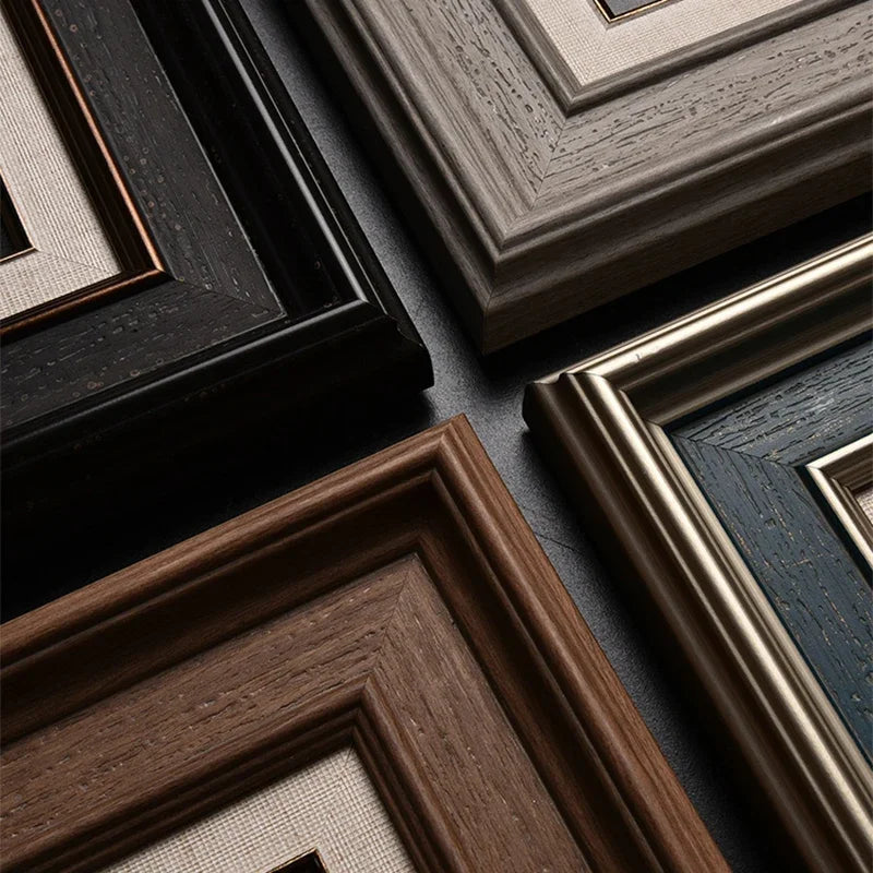 Close-up of various wooden picture frames on a dark surface