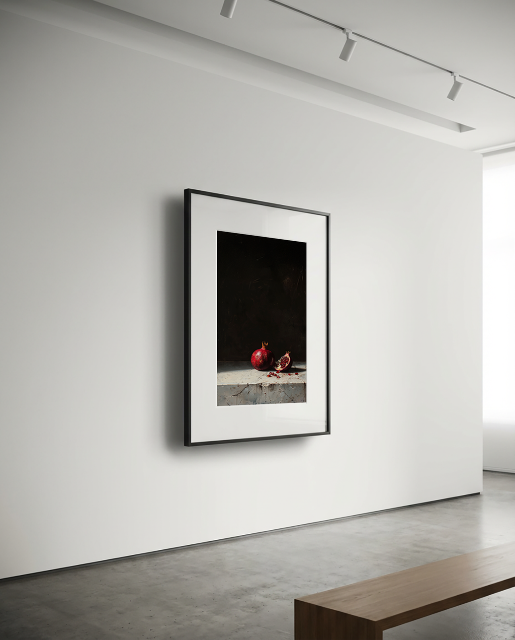 Framed artwork on a white wall in a minimalistic room with a wooden bench.