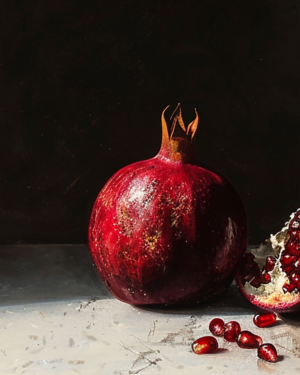 Pomegranate and its seeds on a dark background