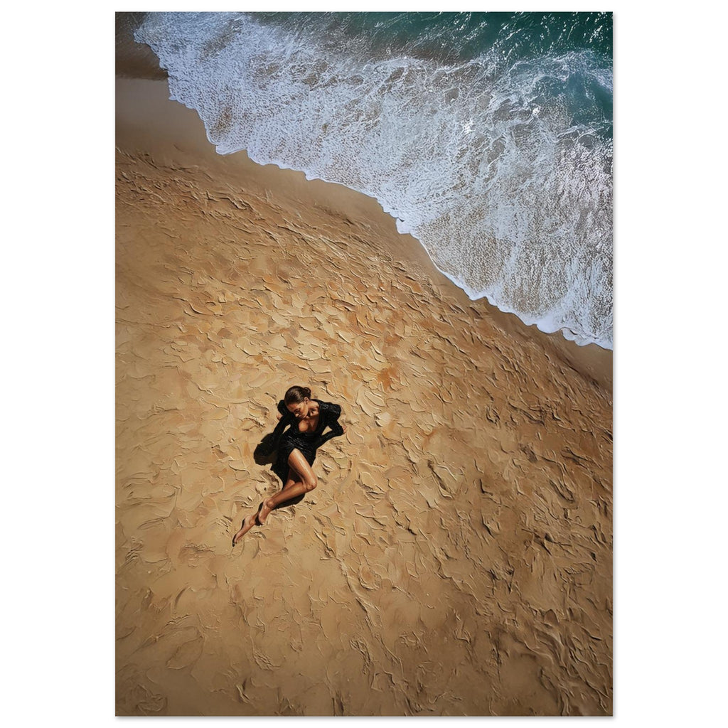 Person lying on a sandy beach with waves in the background