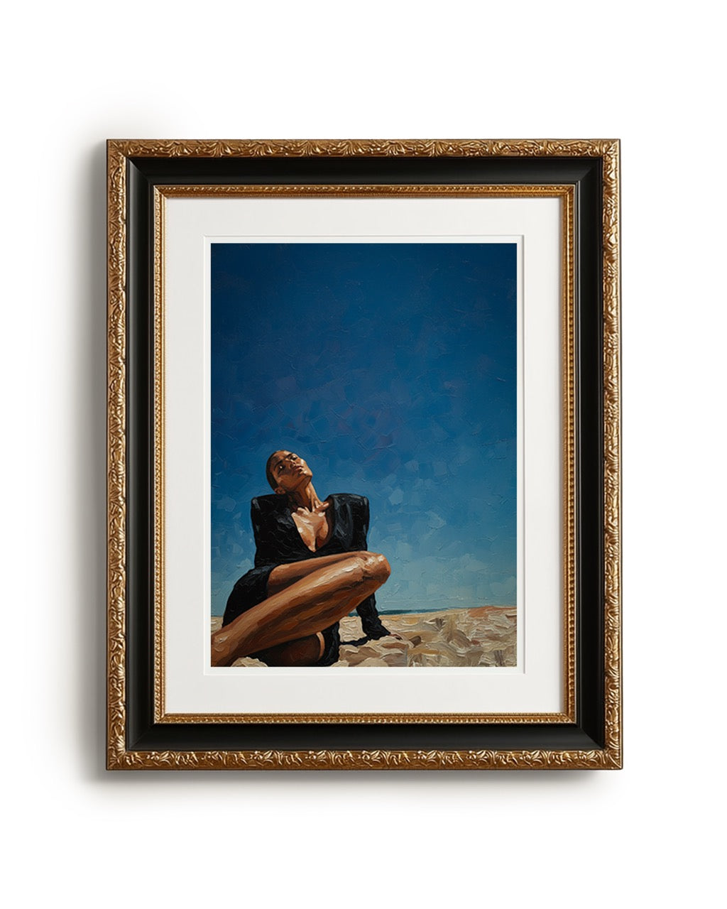 Framed artwork of a person sitting on a beach with a blue sky.