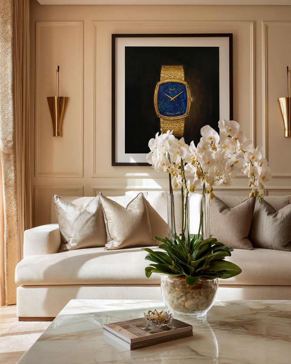 Living room with a white sofa, decorative pillows, a coffee table with a vase of flowers, and a framed picture of a watch on the wall.