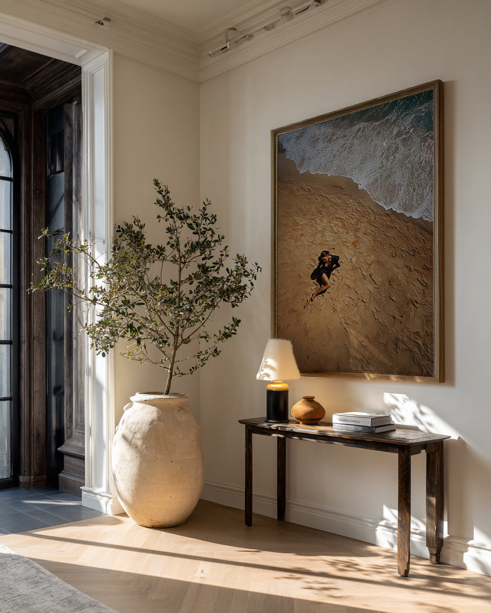 Modern interior with a vase, lamp, and artwork on a wall