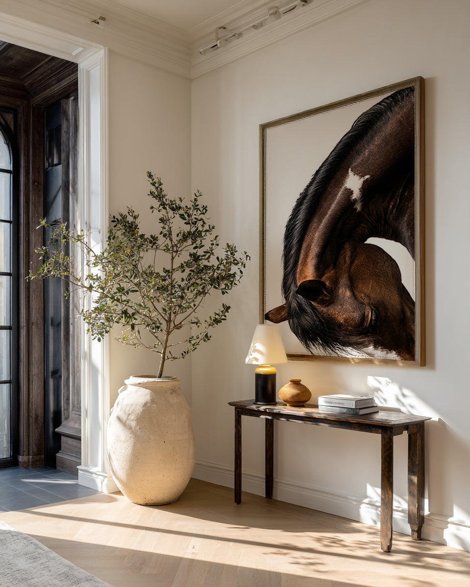 close up photograph of a horse lowering its head in a graceful bow, showing the curved neck and soft lighting
