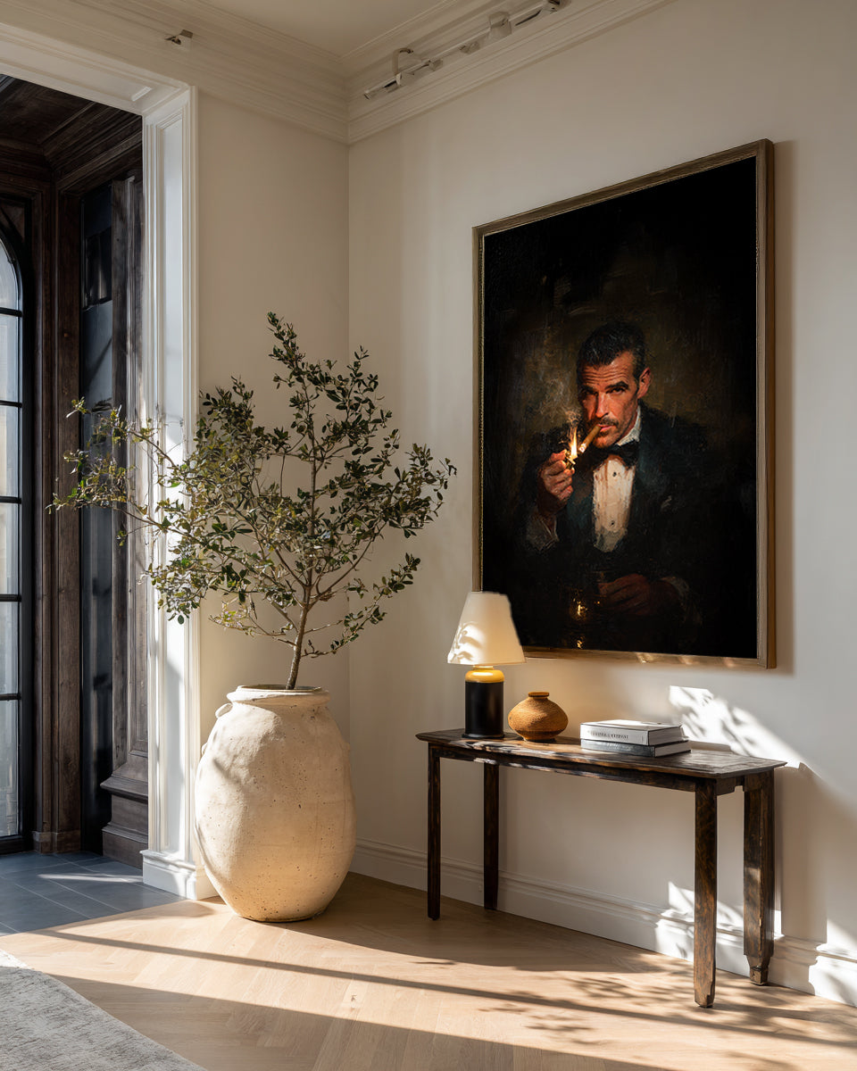 Living room with a large vase, table, and framed portrait on a wall.