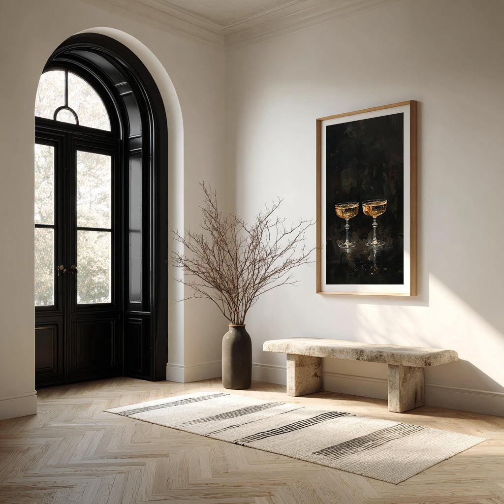 Modern interior with a black door, marble bench, and framed artwork on a white wall.