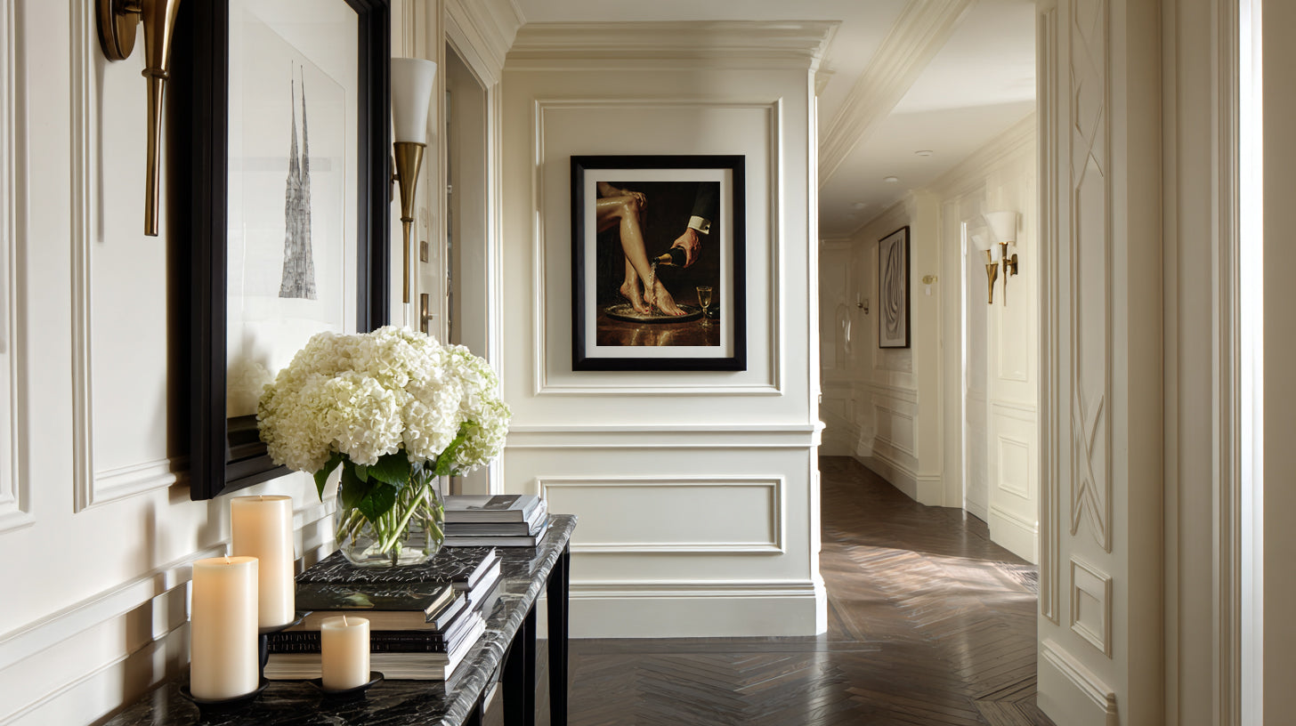 Elegant hallway with decorative elements including a mirror, candles, and framed artwork.