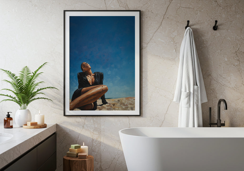 Bathroom interior with a framed artwork of a woman sitting on a rock, a white bathtub, and decorative items.