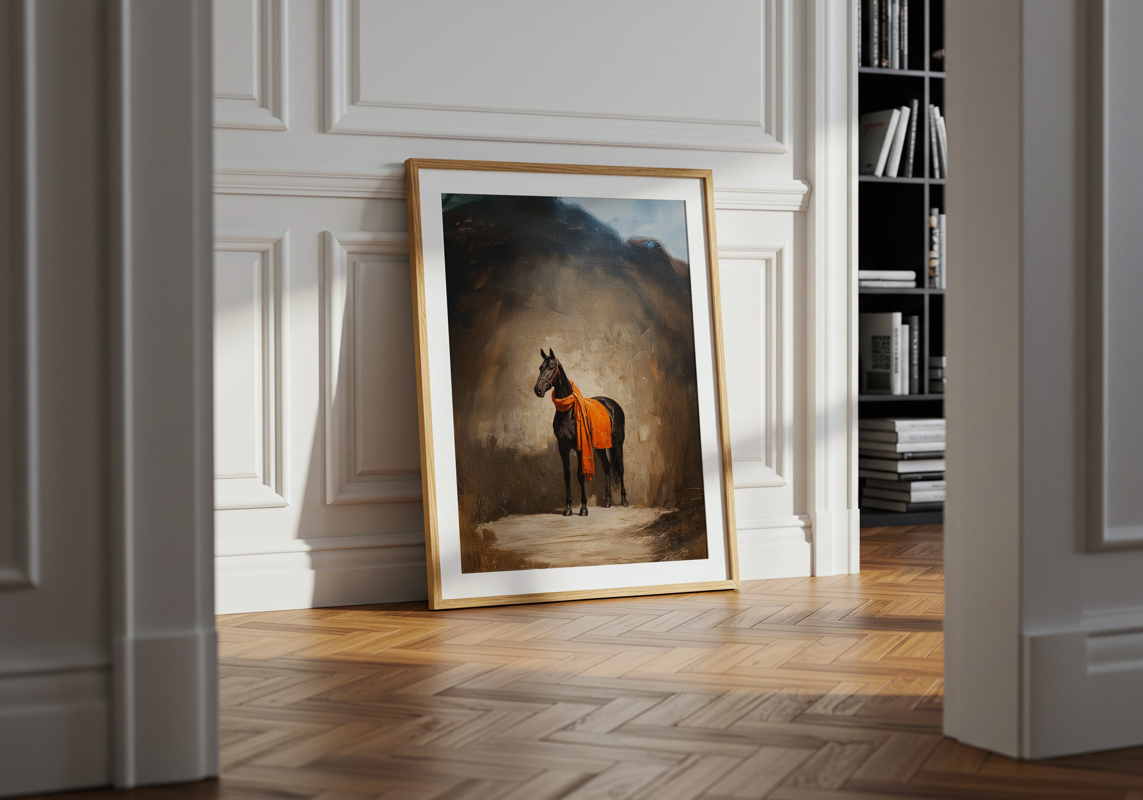 Framed artwork of a horse on a wall in a room with wooden floor and bookshelf.
