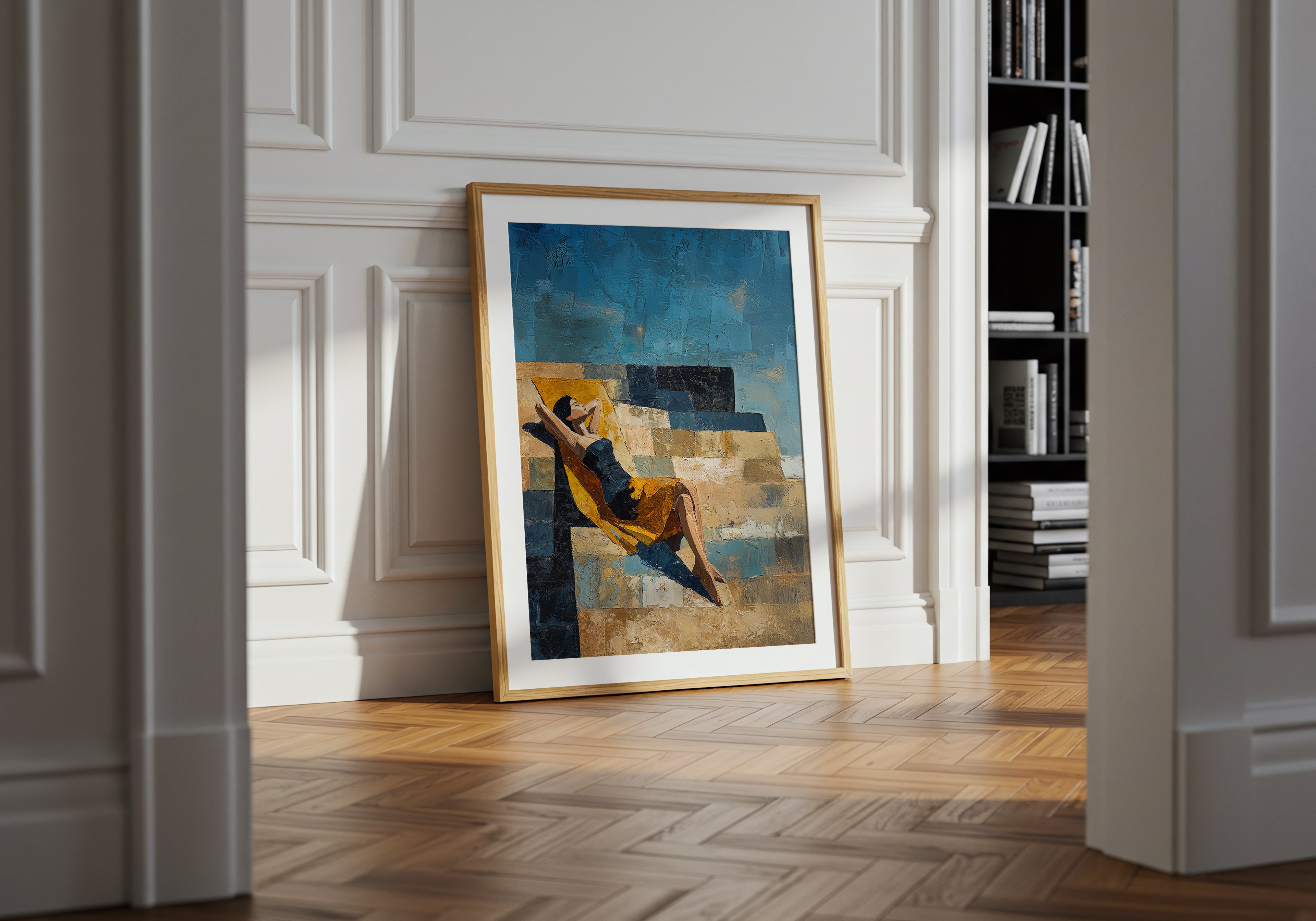 Framed abstract painting on a wall in a room with wooden floor and bookshelf.
