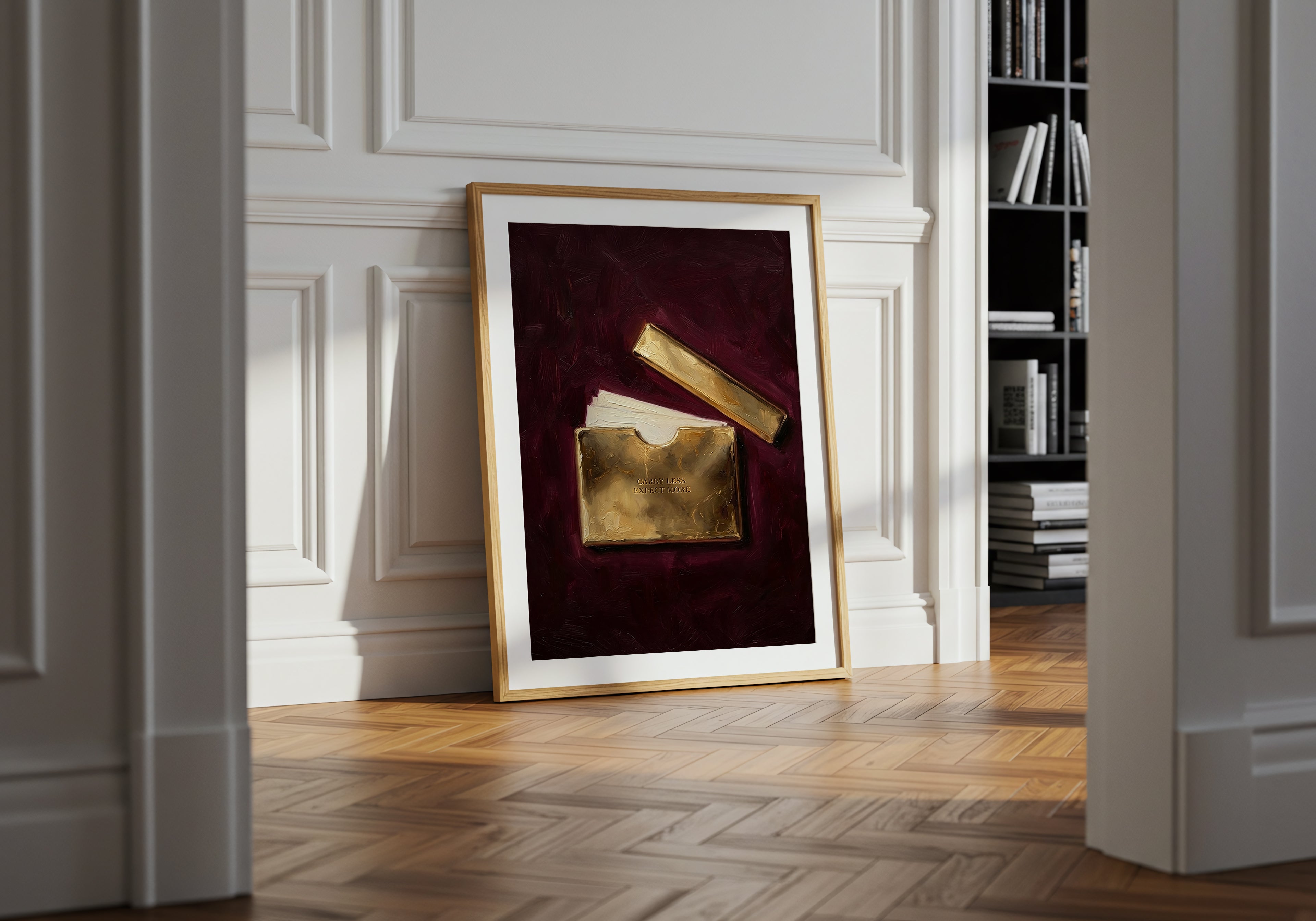 Framed artwork on a wall in a room with wooden flooring and bookshelf.