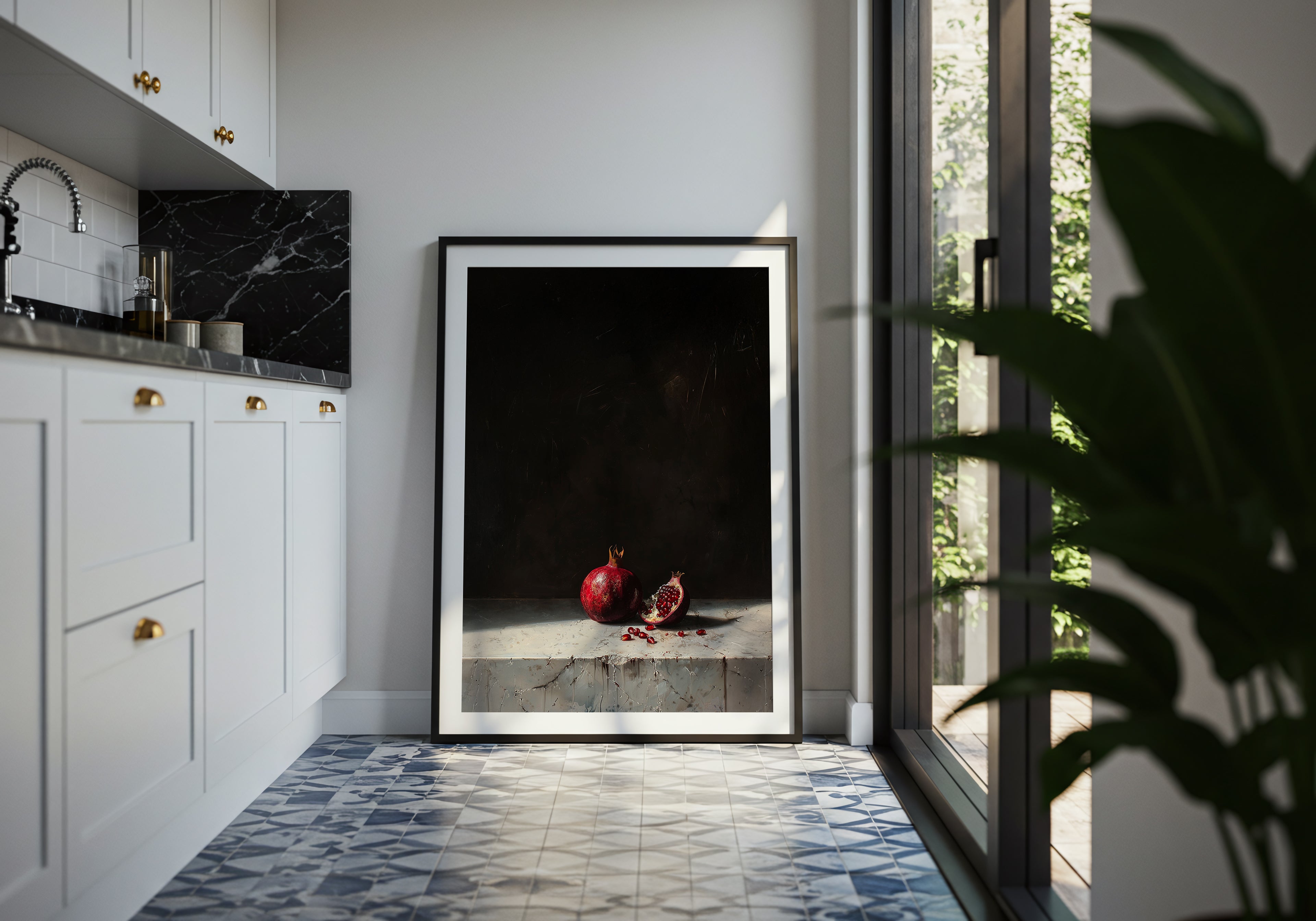 Framed artwork in a modern kitchen with white cabinets and a tiled floor.