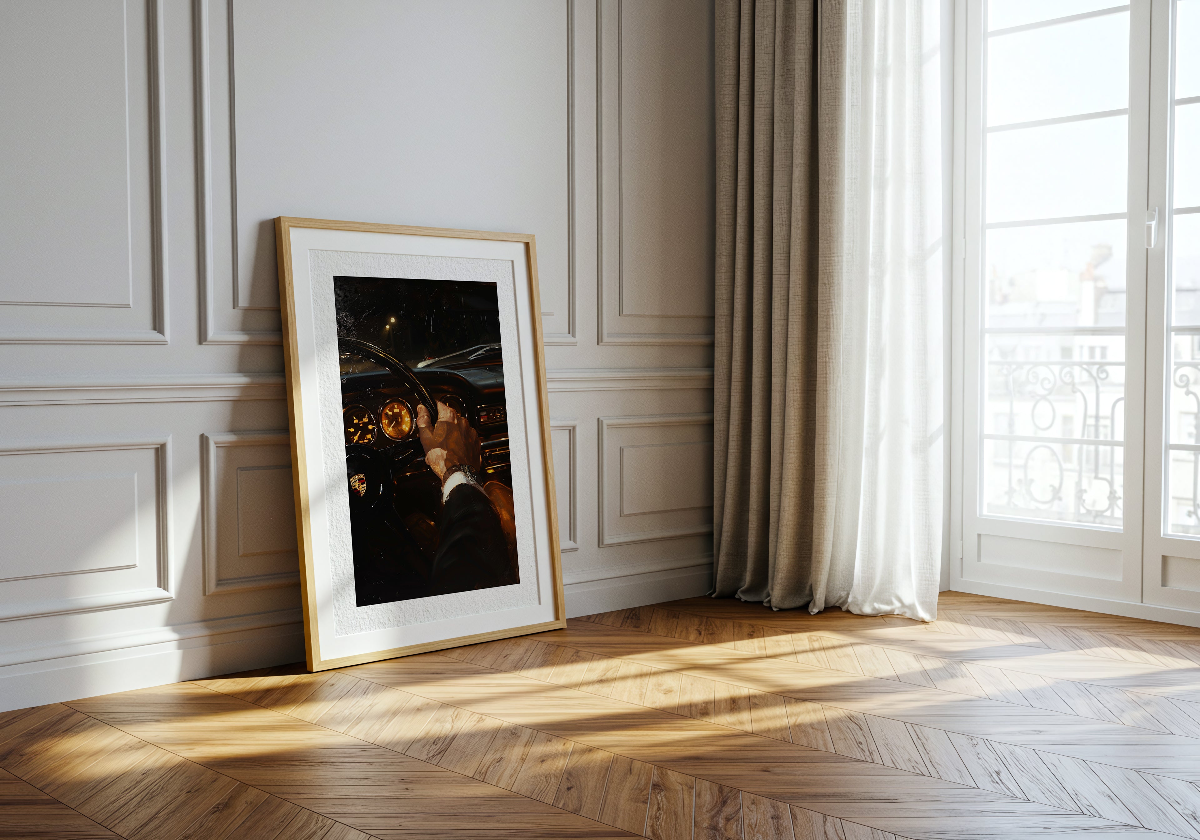 Framed photograph leaning against a wall in a room with wooden flooring and large windows.